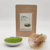 Premium grade Japanese Matcha powder displayed in a dish with a bamboo whisk, in front of J-okini’s 30g Matcha package. Pesticide-free and perfect for traditional tea, Matcha lattes, and sweets. Available at j-okini.com in Malta