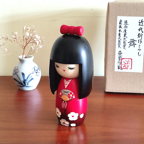 Kokeshi dollHandcrafted Japanese Kokeshi doll in traditional Sakura kimono, featuring intricate details and vibrant colors, perfect for cultural collectors and home decor Malta Mai