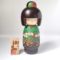 A modern creative Kokeshi doll, Izumino (泉野), by award-winning artist Fujikawa Shoei wears a beautiful kimono in elegant green tones with blooming Japanese irises. Available at j-okini.com in Malta