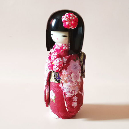 Handcrafted Kokeshi doll in red fabric kimono from Kyoto
