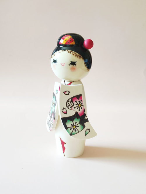 Handcrafted Japanese Kokeshi doll 'Sakura Komachi' by artist Yamagishi Masayoshi, featuring a kanzashi hair bun and a kimono with hand-painted pink and blue cherry blossoms. Available at j-okini.com in Malta