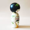 Traditional Japanese wooden Kokeshi doll with summer kimono and Tanzaku motifs