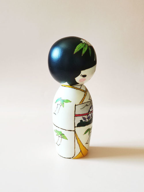 Traditional Japanese wooden Kokeshi doll with summer kimono and Tanzaku motifs