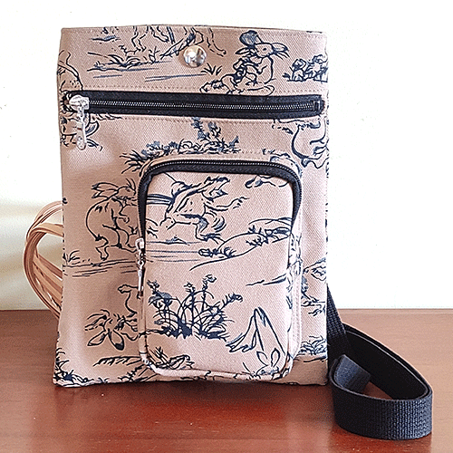 Discover the Essence of Japanese Craftsmanship with Our Handmade Kyoto Bag Crafted with unparalleled attention to detail, this bag embodies the spirit of Kyoto's artisanal heritage. Each piece is meticulously handcrafted by skilled artisans in Kyoto, Japan, using premium materials that blend tradition with durability. It features: - Two secure outer zip pockets for easy access. - An adjustable strap, offering versatile wear as a waist bag or shoulder bag. - A unisex design, making it a perfect accessory for anyone. - Crafted for longevity, ensuring that this bag stands the test of time. A Canvas of Cultural Heritage Adorned with the iconic 鳥獣戯画 Chojyu Giga pattern, this bag pays homage to what is often considered Japan's earliest form of manga. The playful anthropomorphized animals depicted in these scrolls capture the whimsy and depth of Japanese folklore. Color and Composition - Color: Classic Beige, a versatile choice for any wardrobe. - Material: 100% cotton for both the outer and lining - Dimensions: 20cm Width x 25cm Height - Designed to offer ample space for your essentials, this bag combines functionality with aesthetic appeal. Durable Textiles for Everyday Use - Outer material: Hampu 帆布, known for its robust 平織 Hira-ori (plain weave). This technique involves an intricate process of crossing warp and weft threads, enhanced by twisting and weaving multiple threads for unmatched strength. - Lining material: Katsuragi カツラギ, a softer, thinner fabric compared to Hampu, crafted from 綾織 Aya-ori (twill weave). This method creates a diagonal alignment of warp and weft intersections, offering durability with a gentle touch. Available at j-okini.com in Malta