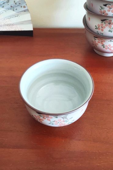 This exquisite teacup features delicate cherry blossoms and leaves painted on the front, with soft, pale purplish-pink hues and scattered Sakura petals adorning the entire surface. A true blend of elegance and tradition, this cup is perfect for both everyday use and as a decorative piece. Available at j-okini.com in Malta