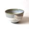 Kiyomizu-ware handmade matcha bowl with Hakeme brushstroke technique on a gray base, with white strokes and hints of light blue by artist Hiroki Shirai.| j-okini Malta