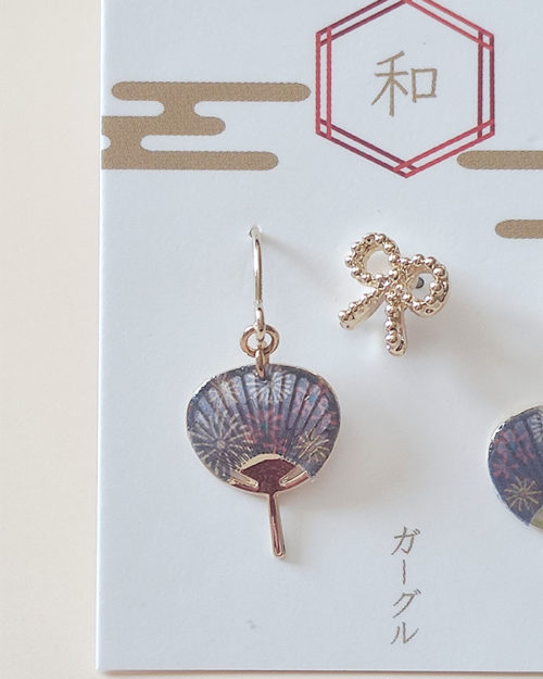 Japanese earring set including two mini uchiwa fan featuring a vibrant fireworks (hanabi) pattern earrings with hooks , paired with a cute ribbon stud earring. Uchiwa fan has the desi Made in Japan! Available at j-okini.com in Malta