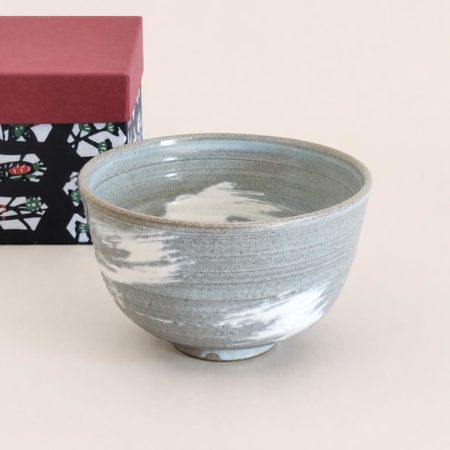 Kiyomizu-ware handmade matcha bowl with Hakeme brushstroke technique on a gray base, with white strokes and hints of light blue by artist Hiroki Shirai. j-okini.com in Malta