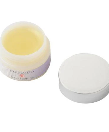 A compact solid perfume container with a Japanese Zen-inspired lotus design, featuring a woody-sweet floral scent. Made with natural oils for skin nourishment, ideal for travel or gifting. j-okini.com in Malta