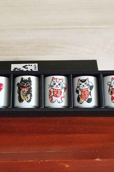 A 5-piece Mino ware sake cup set featuring colorful Maneki-Neko designs, each representing luck, protection, or prosperity. Available at j-okini.com in Malta
