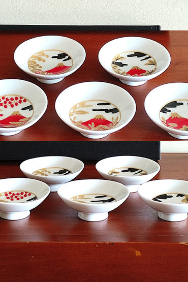 A 5-piece Sakazuki sake cup set featuring Red Fuji with intricate designs of cherry blossoms, waves, and autumn leaves, accented in gold and red for an elegant, celebratory touch. Available at j-okini.com in Malta