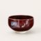 A handmade Kiyomizu-ware Matcha bowl by Okayama Kousha, featuring a deep amber glaze with vibrant blue accents, a low tube shape, and a wide opening for easy use. available at j-okini.com in malta