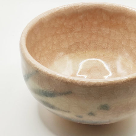 Kiyomizu-ware handmade Matcha bowl by Okayama Kousha, featuring a warm light coral and skin-tone hue with a delicate cracked-glass pattern. Tube-shaped for excellent heat retention, with unique random grey accents on the front. Stamped at the bottom. Made in Japan. Available at j-okini.com in Malta