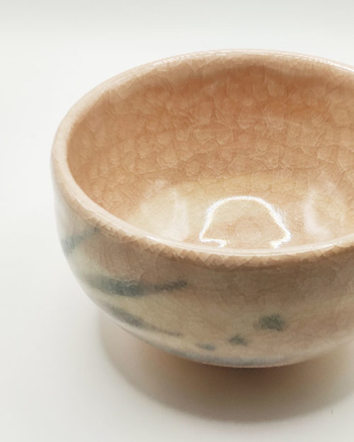 Kiyomizu-ware handmade Matcha bowl by Okayama Kousha, featuring a warm light coral and skin-tone hue with a delicate cracked-glass pattern. Tube-shaped for excellent heat retention, with unique random grey accents on the front. Stamped at the bottom. Made in Japan. Available at j-okini.com in Malta