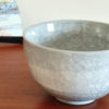Kiyomizu-ware handmade Matcha bowl by Okayama Kousha, featuring a soft grey blend with a delicate cracked-glass pattern. Classic bowl shape for easy handling, stamped at the bottom. Made in Japan. Available at j-okini.com in Malta