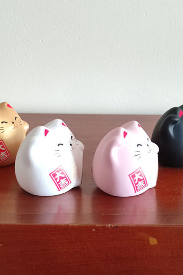 Banko Ware Maneki-Neko in white, pink, gold, and black, each representing different meanings in Feng Shui—health, love, wealth, and protection. Made in Japan. Available at j-okini.com in Malta