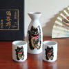 Mino ware porcelain sake set featuring a black Maneki Neko with a smiley face, symbolizing protection and good fortune. Available at j-okini.com in Malta