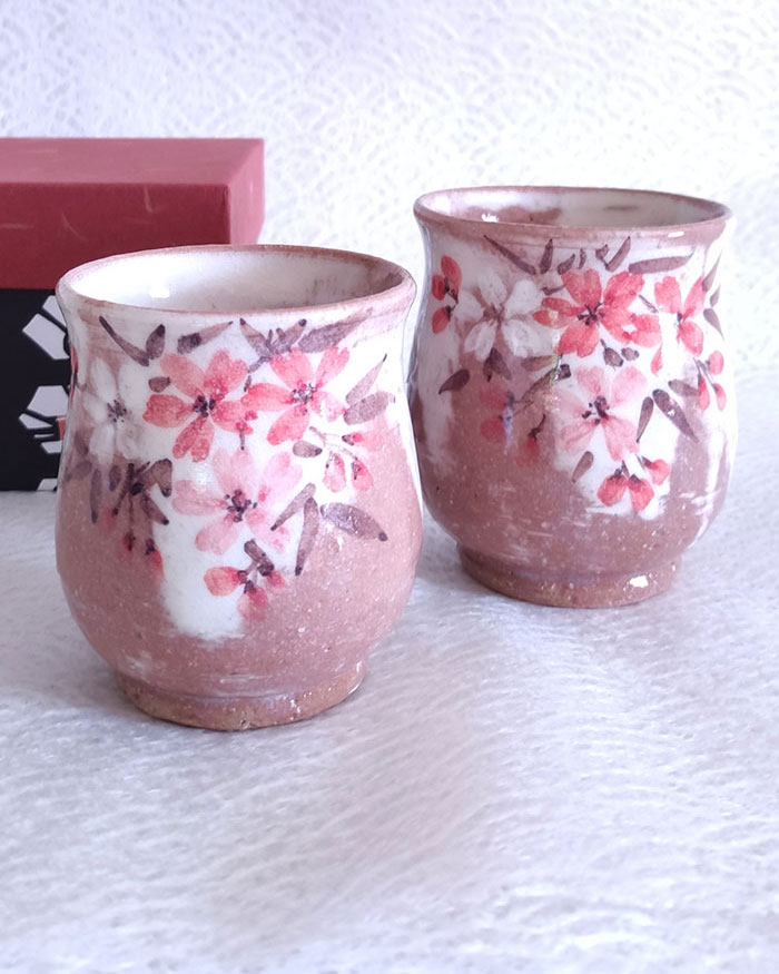 Handmade Kiyomizu-yaki Yunomi Tea Cup featuring a delicate sakura (cherry blossom) design in a soft, light reddish tone. Made in Japan. Available at j-okini.com in Malta