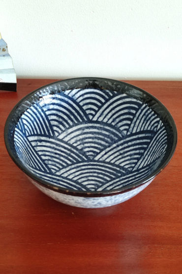 A traditional Japanese Mino ware donburi bowl featuring a deep blue Seigaiha wave pattern. With a 600ml capacity, 16cm diameter, and 8cm height, it's ideal for rice dishes, udon, or instant noodles. Beautifully crafted with a smooth glaze, showcasing the elegance of Japanese ceramics. Made in Japan. Available at j-okini.com in Malta