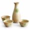 A glazed Kiseto Sake Set with a beige tokkuri bottle and matching sake cups, each featuring soft green accents and a smooth, speckled finish. Made in Japan. Available at j-okini.com in Malta