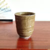 Tall Mino ware teacup with brown Oribe glaze, made in Japan. Available at j-okini.com in Malta