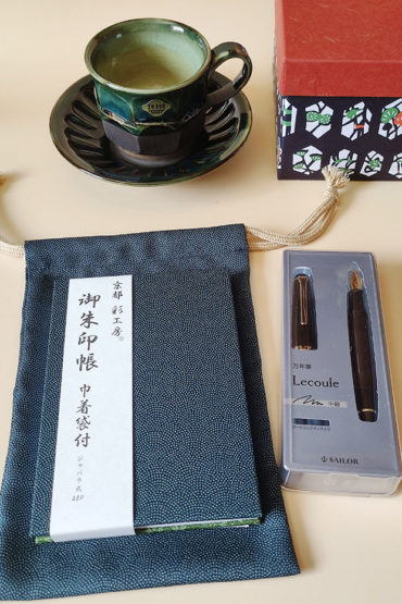 Gift set consists of Handcrafted Kiyomizu Ware coffee cup and saucer in earthy tones, Sailor fountain pen, Japanese Goshuincho accordion notebook with a matching drawstring pouch. Available at j-okini.com in Malta