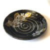 Black porcelain plate with a spiral-carved surface and gold and silver painted Hydrangea – part of a seasonal Japanese Mino-yaki plate set. Available at j-okini.com in Malta