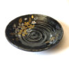 Black porcelain plate with a spiral-carved surface and gold and silver painted cherry blossoms – part of a seasonal Japanese Mino-yaki plate set. Available at j-okini.com in Malta
