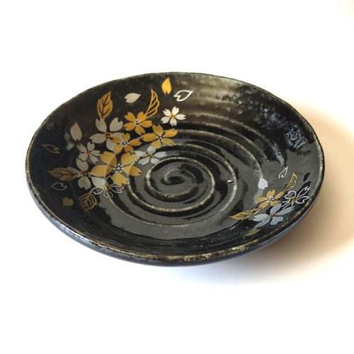 Black porcelain plate with a spiral-carved surface and gold and silver painted cherry blossoms – part of a seasonal Japanese Mino-yaki plate set. Available at j-okini.com in Malta