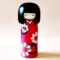 Hana Guruma Kokeshi doll in dark red kimono with white and black flowers, handcrafted in Japan by Usaburo. Buy it online at j-okini.com in Malta