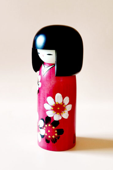 Handmade Hana Guruma wooden Kokeshi doll in floral dark red kimono by Japanese artist Usaburo.. Order online at j-okini.com in Malta
