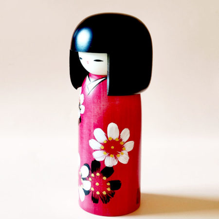 Handmade Hana Guruma wooden Kokeshi doll in floral dark red kimono by Japanese artist Usaburo.. Order online at j-okini.com in Malta