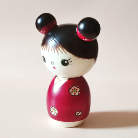 Cute Japanese wooden doll – Mujaki Kokeshi in vibrant red kimono with carved flowers, handcrafted by Chie. Buy it online at j-okini.com in Malta