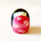 "Negai Kokeshi doll in pink floral kimono with yellow hair ribbon, handcrafted in Japan by Usaburo. Buy online at j-okini.com in Malta
