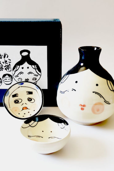 Japanese ceramic sake set with Okame and Hyottoko designs. Made in Japan. Available at j-okini.com in Malta