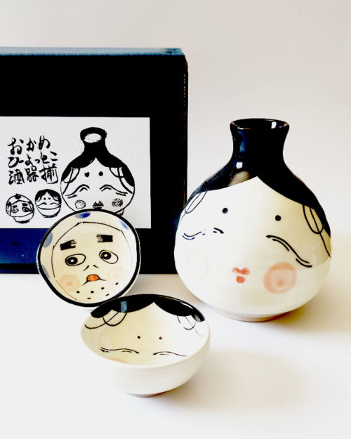 Japanese ceramic sake set with Okame and Hyottoko designs. Made in Japan. Available at j-okini.com in Malta