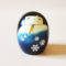 Yuki no Sei Kokeshi doll in deep blue snowflake kimono with white sleeves and yellow inner lining, handcrafted by Usaburo in Japan. buy online at j-okini.com in Malta