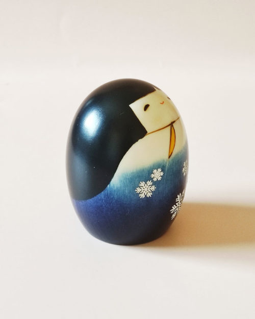Handmade wooden Kokeshi doll Yuki no Sei in blue snowflake kimono, modern creative design by Usaburo.