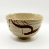 Vintage handmade beige Japanese matcha bowl with brush stroke design and artist’s impressed mark. available at j-okini.com in Malta