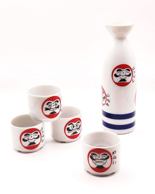 A Japanese Mino ware sake set featuring a tokkuri bottle and four cups with Daruma faces and Janome blue double-circle design, made in Japan.. Available at j-okini.com in Malta