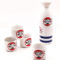 A Japanese Mino ware sake set featuring a tokkuri bottle and four cups with Daruma faces and Janome blue double-circle design, made in Japan.. Available at j-okini.com in Malta