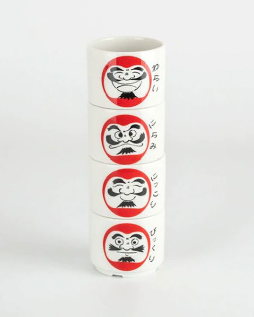 An elegant Mino ware set includes one Tokkuri (sake bottle) and four Ochoko (sake cups), each decorated with the four expressive faces of Daruma: Smiling (Nikkori), Laughing (Warai), Glancing (Nirami), and Surprised (Bikkuri).. Available at j-okini.com in Malta