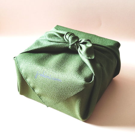 A Matcha bowl wrapped in green j-okini furoshiki. Elegant furoshiki gift wrapping. Japanese gift shop based in Malta