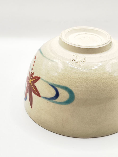 Vintage handmade Kyo-yaki Matcha bowl with maple leaf and sakura design on cream glaze, accented with blue curved lines.