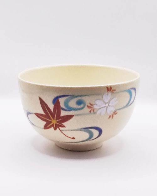 Vintage handmade Kyo-yaki Matcha bowl with maple leaf and sakura design on cream glaze, accented with blue curved lines. Available at j-okini.com in Malta