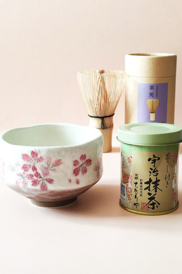 A simple Matcha set including Uji Matcha in a tin, a Matcha bowl with a sakura design made in Japan and Matcha whisk