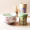 A simple Matcha set including Uji Matcha in a tin, a Matcha bowl with a sakura design made in Japan and Matcha whisk