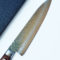 Japanese 180mm Gyutou kitchen knife with hammered Tsuchime finish and VG10 Damascus steel blade.. Available at j-okini.com in Malta