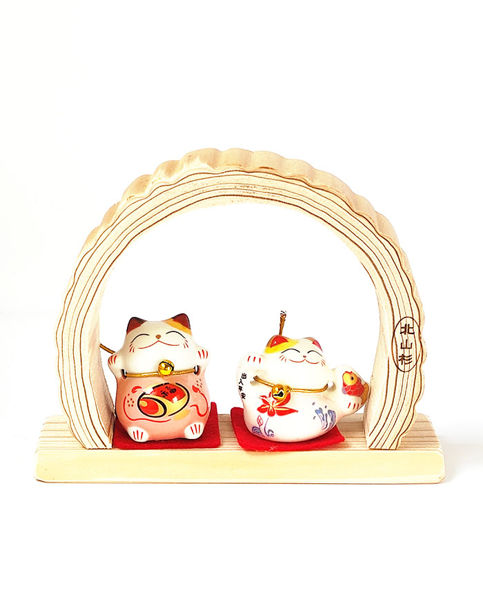 Two ceramic Maneki Neko lucky cats on a Kitayama cedar arch base, traditional Japanese ornament from Kyoto. Available at j-okini.com