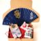 Japanese Father’s Day gift box with sushi tea cup, samurai folding fan, grey tabi socks, and lucky Daruma doll in gift box.